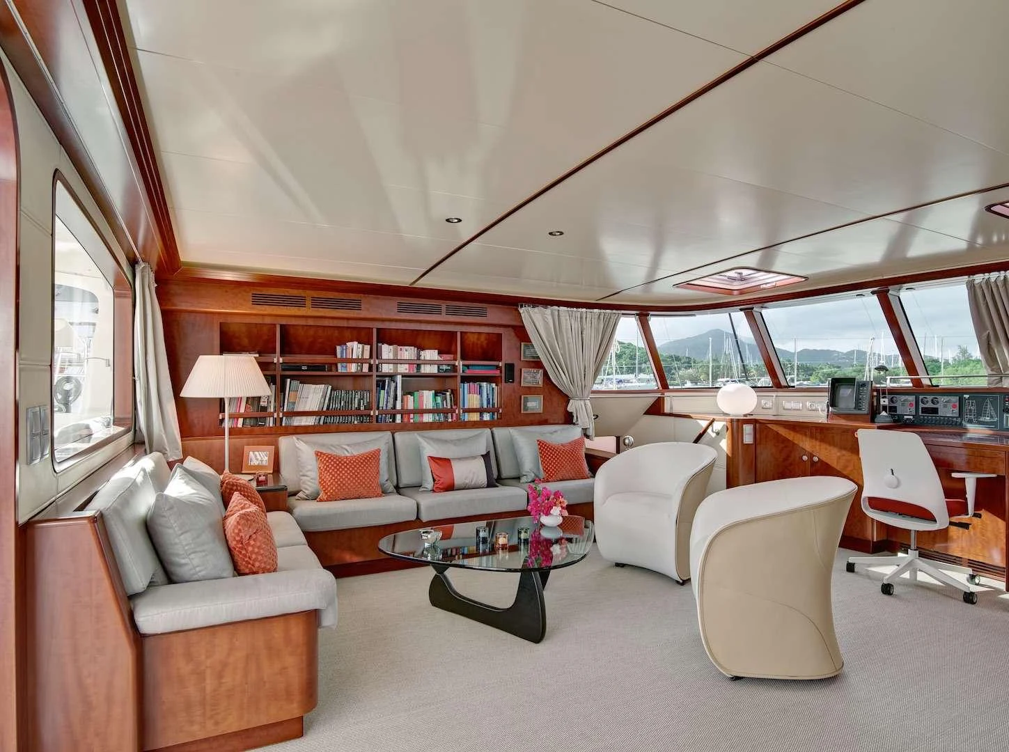 The salon features elegant seating, a modern coffee table, and large windows offering panoramic views. aboard AZIZAM Yacht for Charter