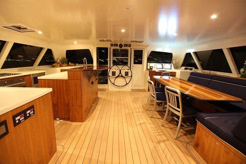 a large kitchen with a large island aboard SLIM Yacht for Charter