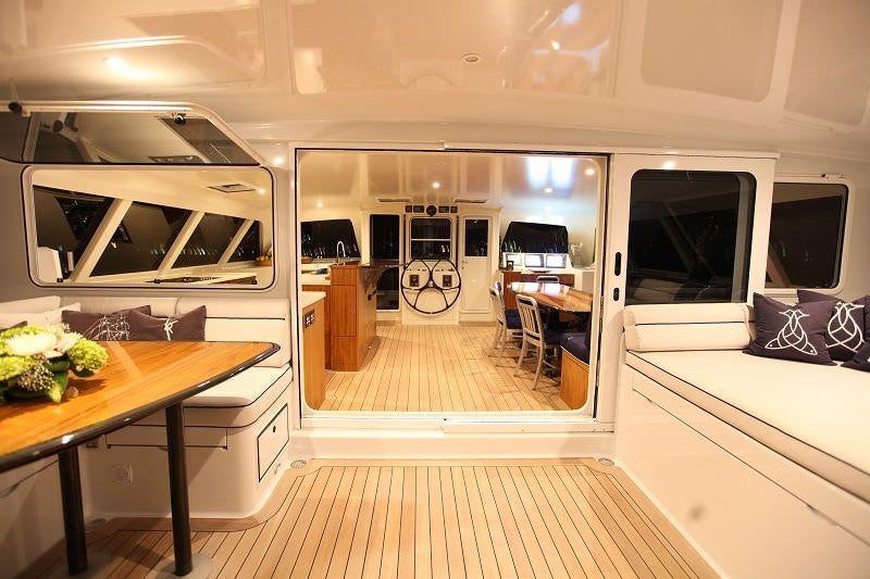 a room with a table and chairs aboard SLIM Yacht for Charter