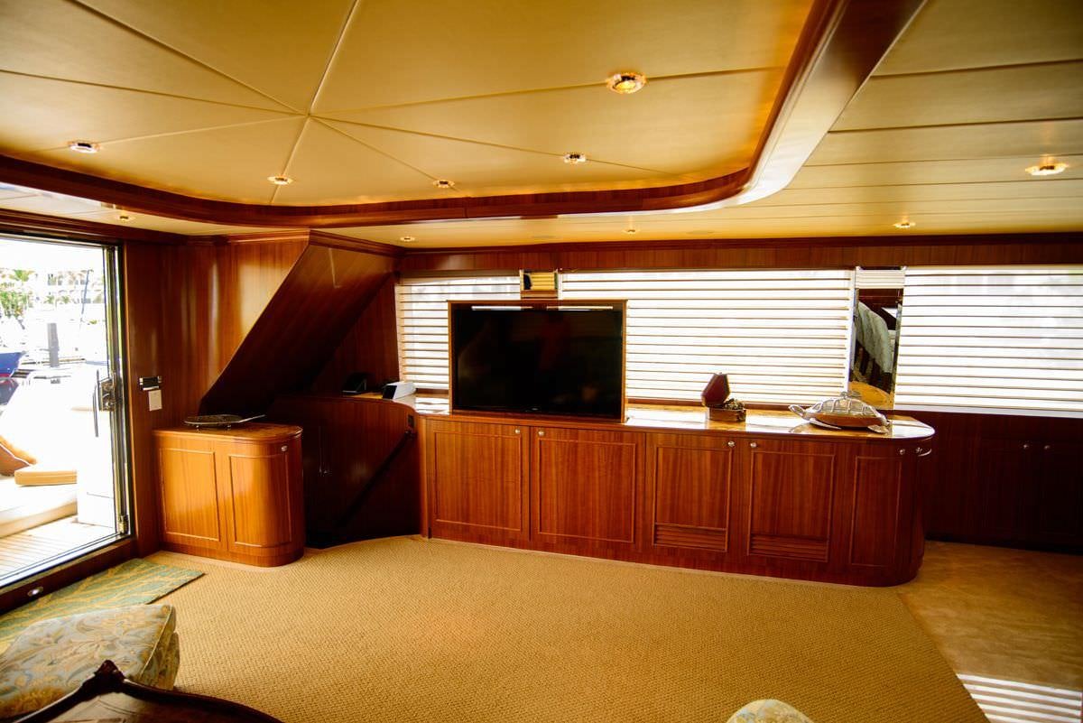 a room with a tv and cabinets aboard KENTUCKY BELLE Yacht for Charter
