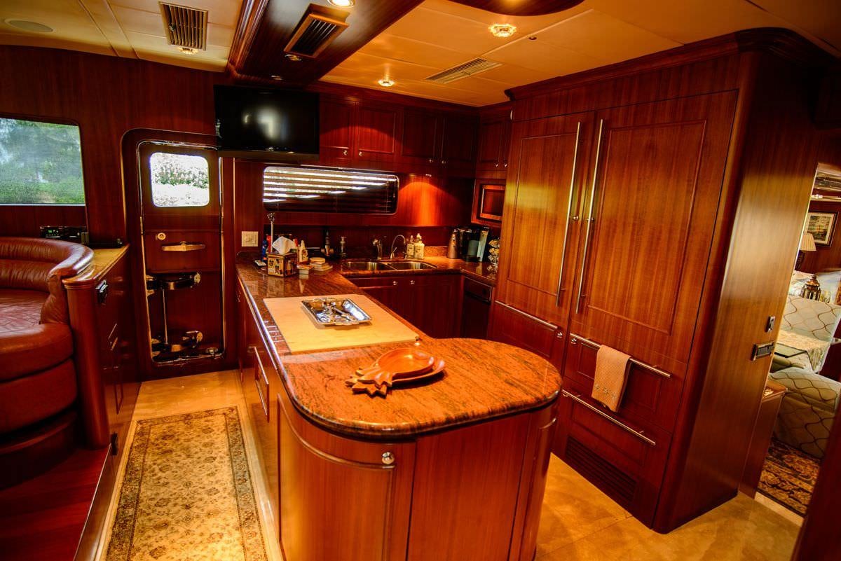 a kitchen with wooden cabinets aboard KENTUCKY BELLE Yacht for Charter