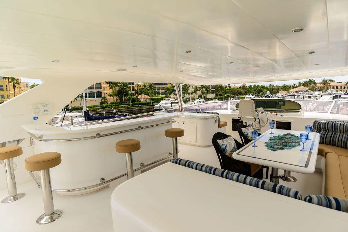 a room with a table chairs and a large window aboard KENTUCKY BELLE Yacht for Charter