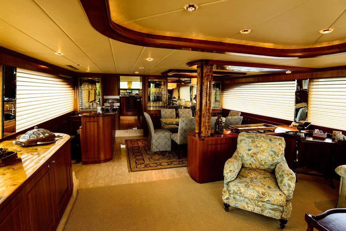 a living room with a couch and a piano aboard KENTUCKY BELLE Yacht for Charter