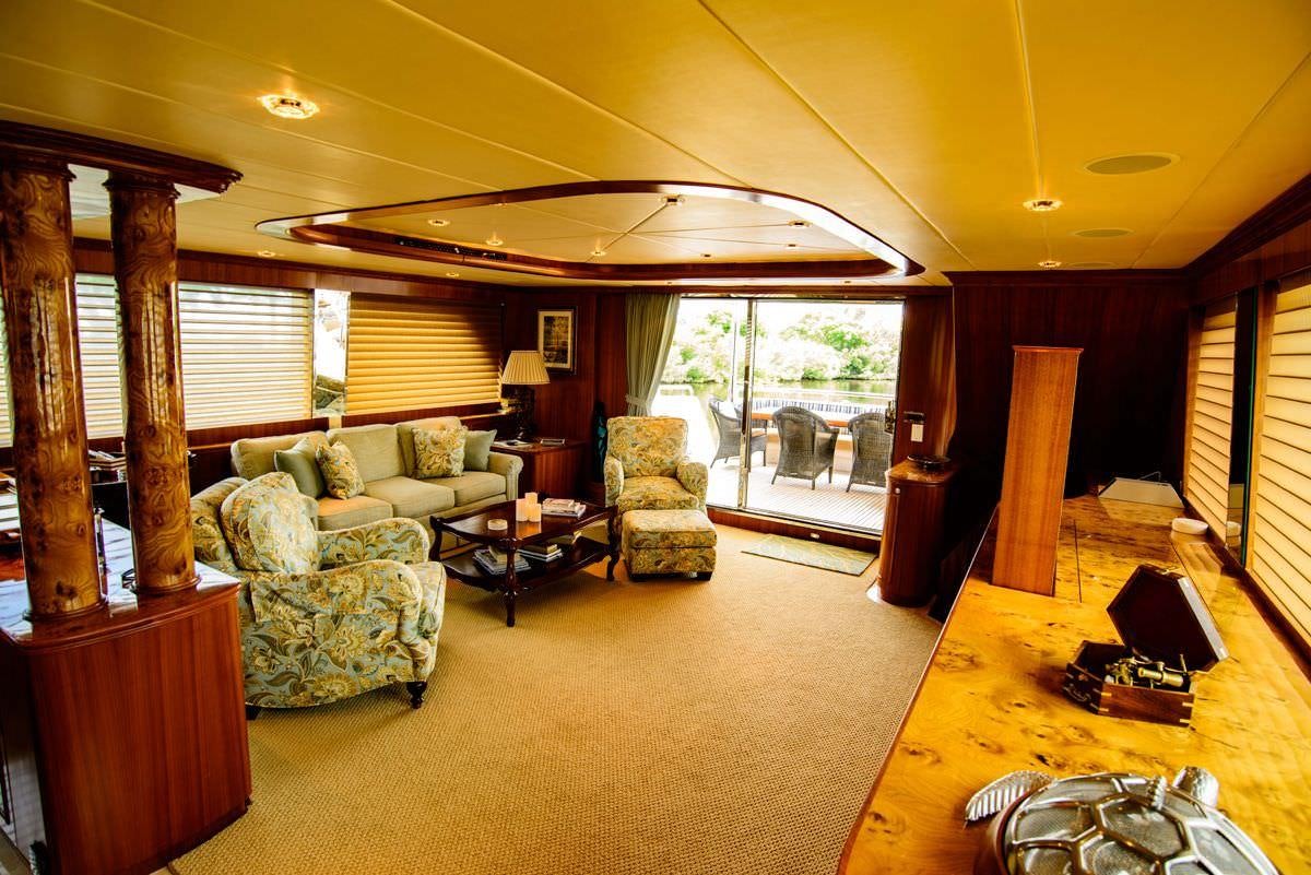 a living room with a large window aboard KENTUCKY BELLE Yacht for Charter