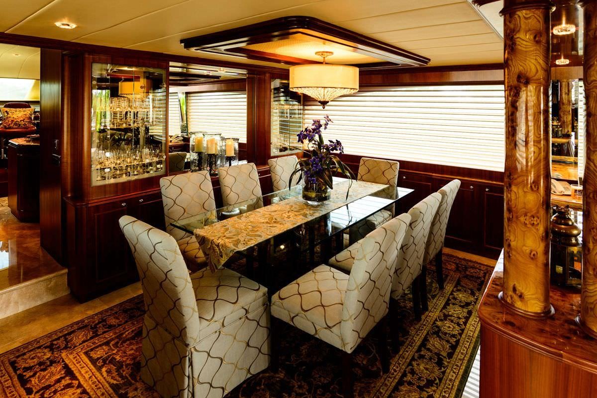 a dining room with a table and chairs aboard KENTUCKY BELLE Yacht for Charter