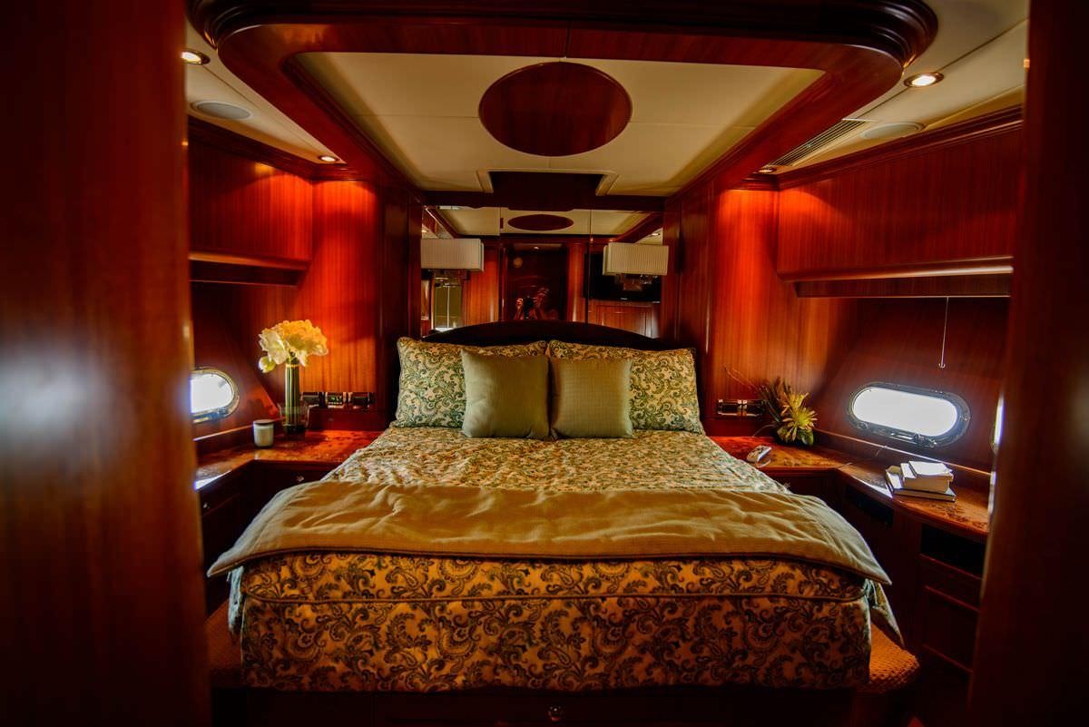 a bed with a bed and a television on it aboard KENTUCKY BELLE Yacht for Charter