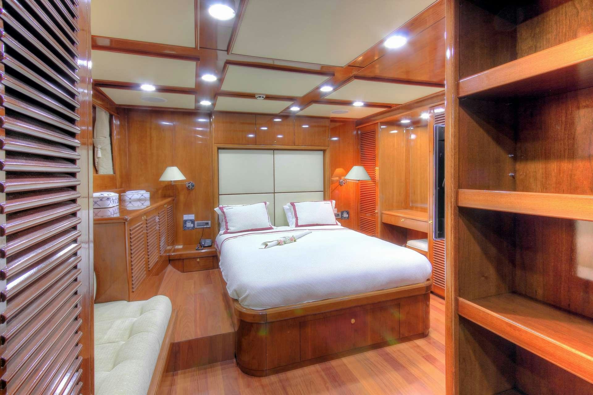 a bedroom with a bed and a desk aboard SEA DREAM Yacht for Charter