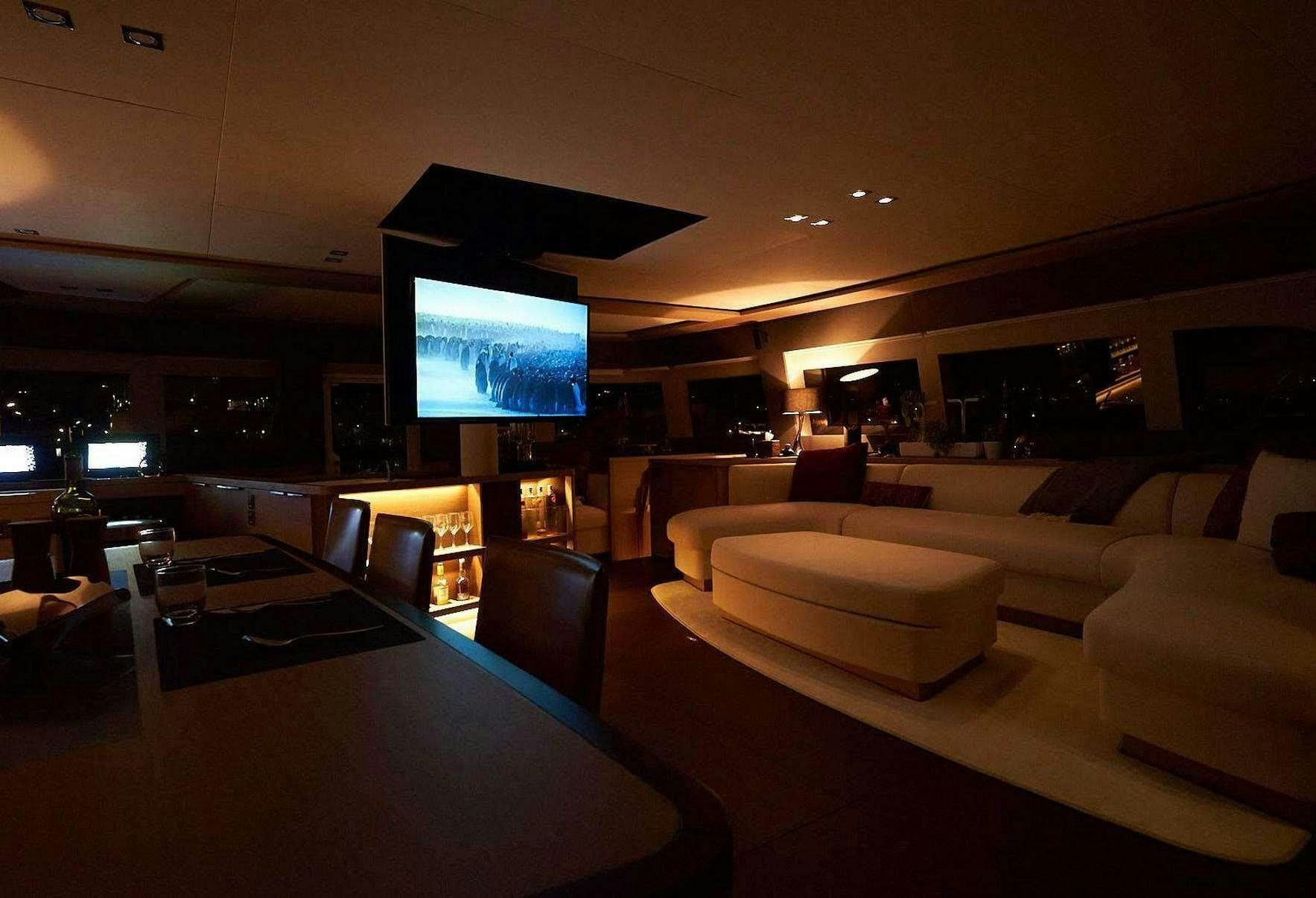 a large room with a large screen aboard BABAC Yacht for Charter