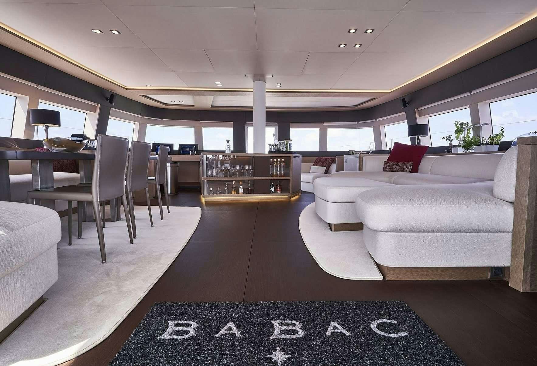 a large living room with a large window aboard BABAC Yacht for Charter