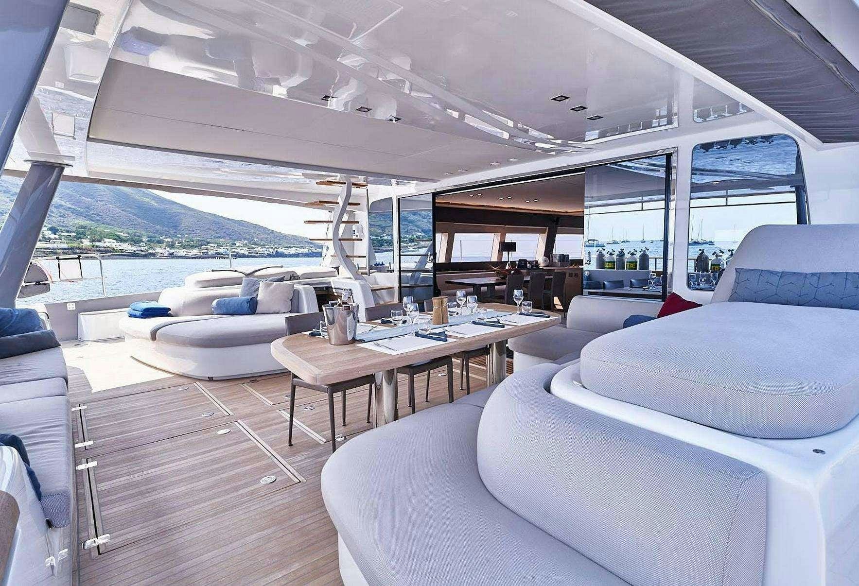 a boat with a table and chairs aboard BABAC Yacht for Charter