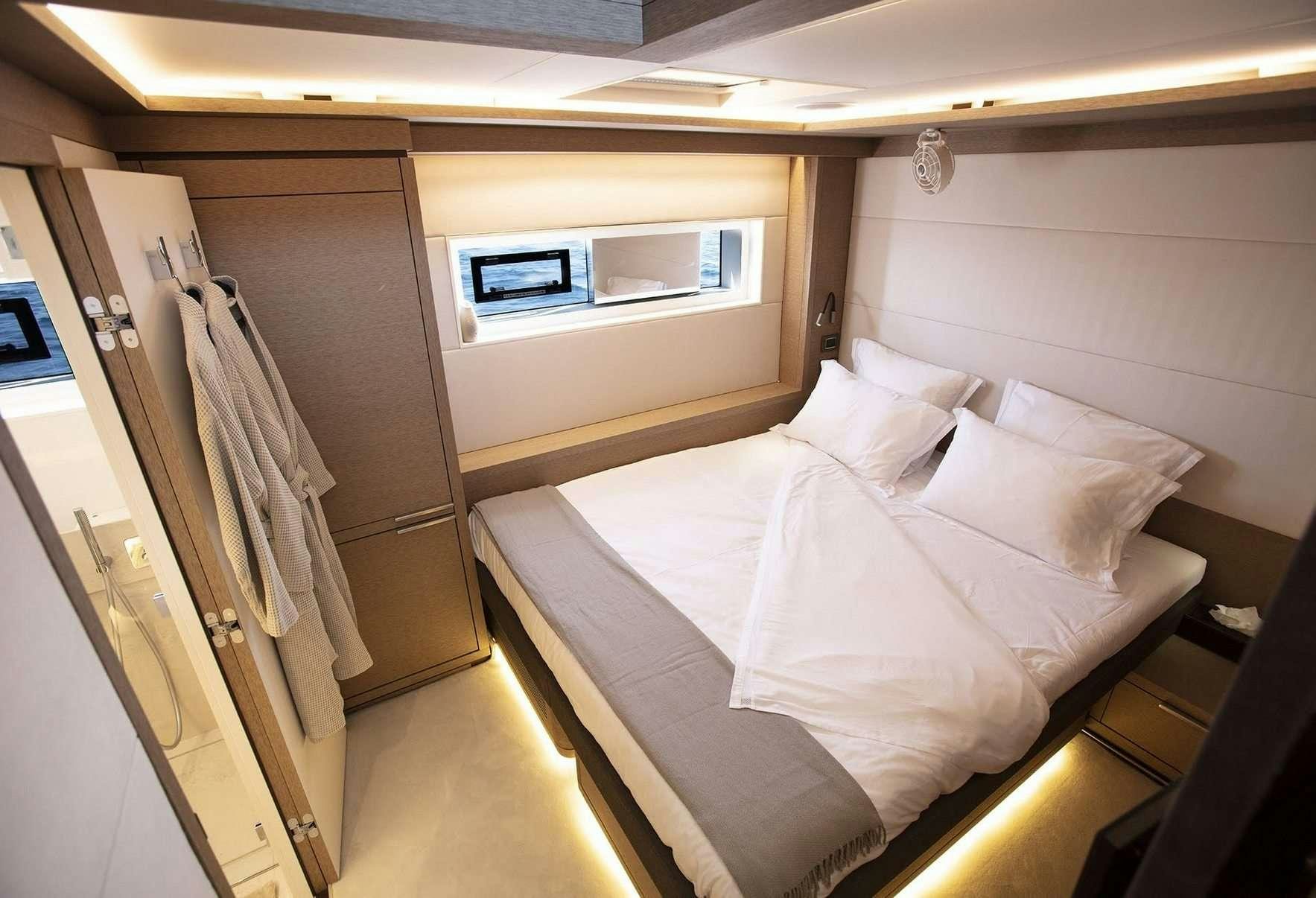 a room with a bed and a window aboard BABAC Yacht for Charter