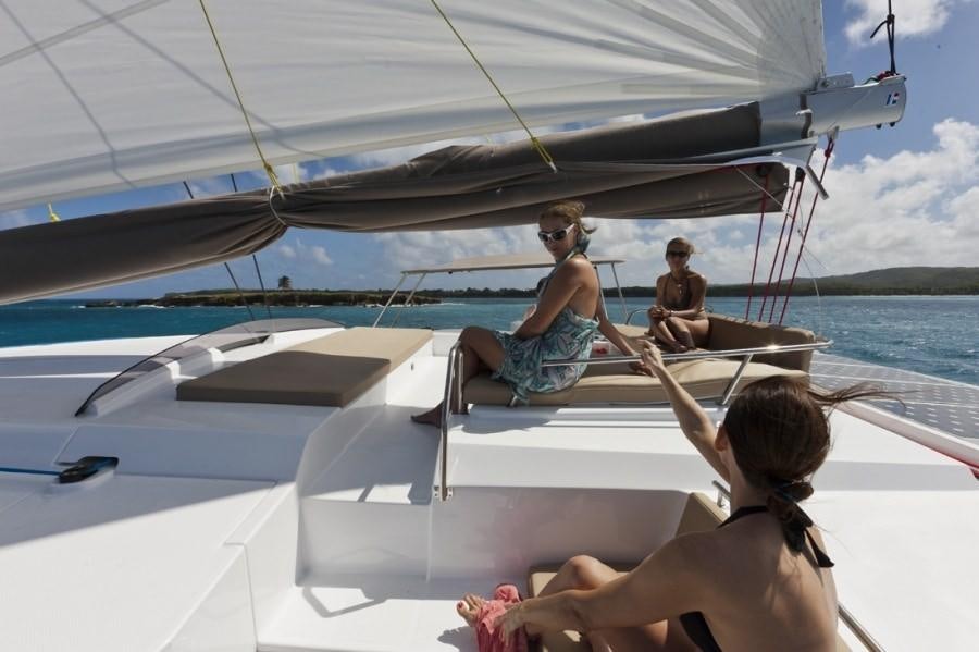 a group of people sitting on a boat aboard ALIVE Yacht for Charter