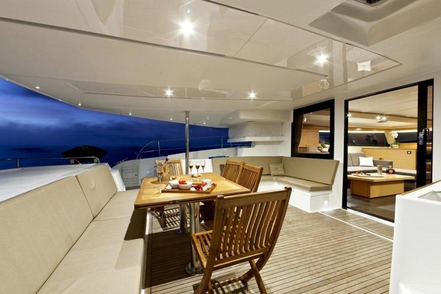 a room with a table and chairs aboard ALIVE Yacht for Charter