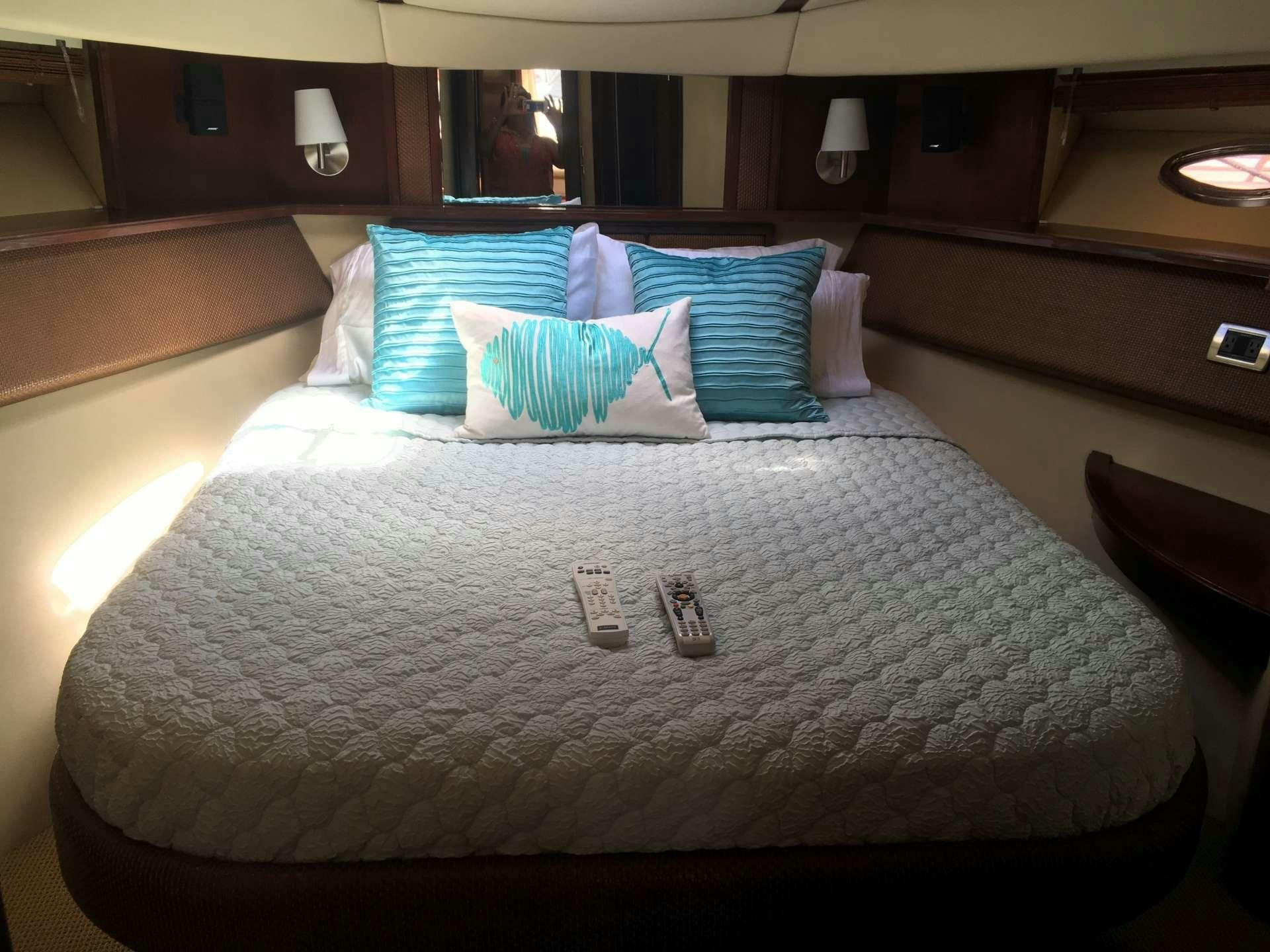 a bed with pillows aboard FUN CLUB Yacht for Charter