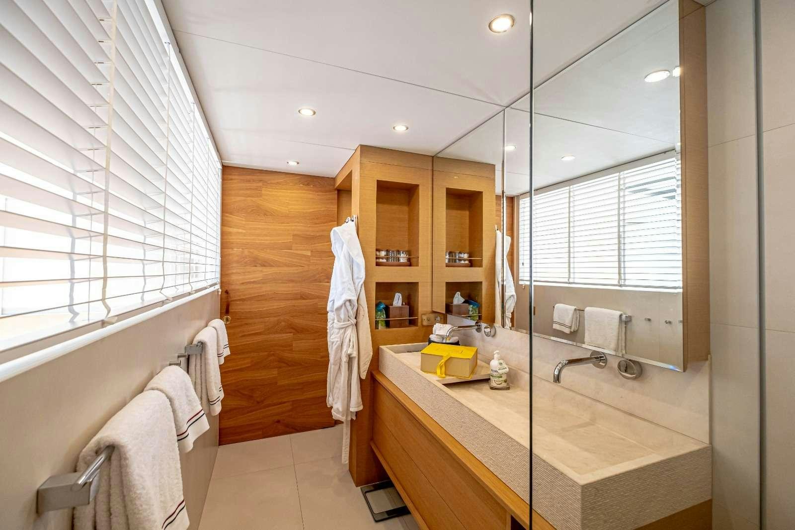 a bathroom with a countertop sink and a mirror aboard HARUN Yacht for Charter