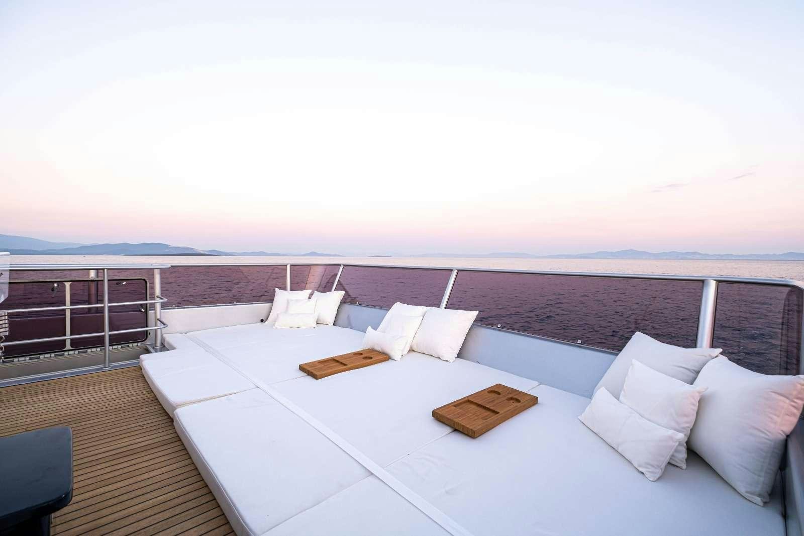 a large white bed with a view of the ocean aboard HARUN Yacht for Charter