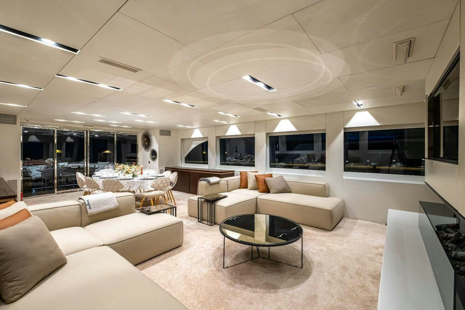 a living room with a large screen aboard HARUN Yacht for Charter