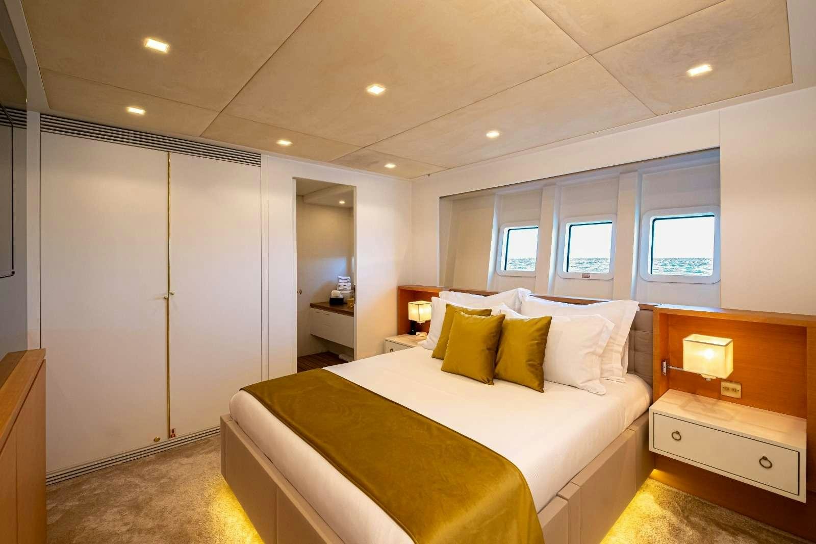 a bedroom with a bed and a desk aboard HARUN Yacht for Charter