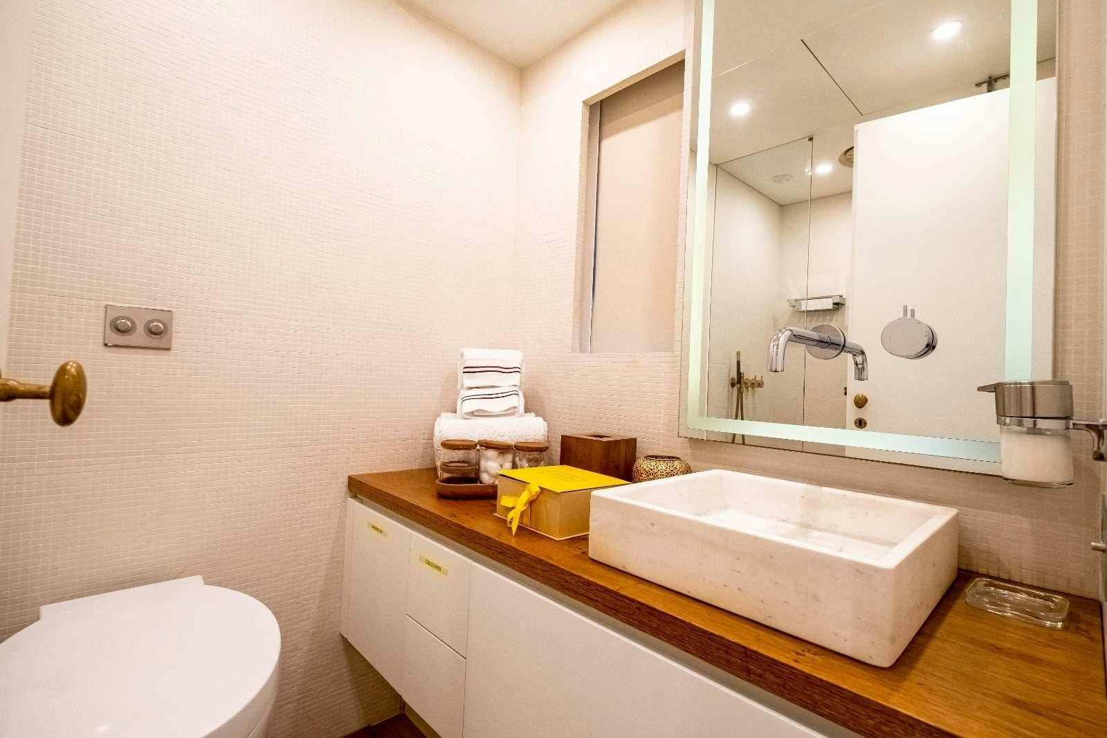 a bathroom with a large mirror aboard HARUN Yacht for Charter