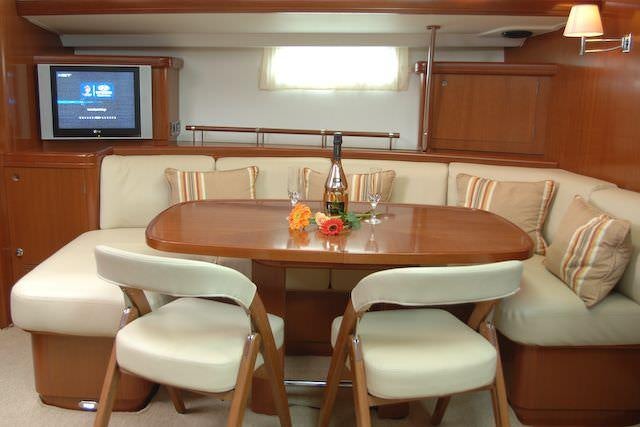 a table with chairs and a television aboard SEA STAR Yacht for Charter