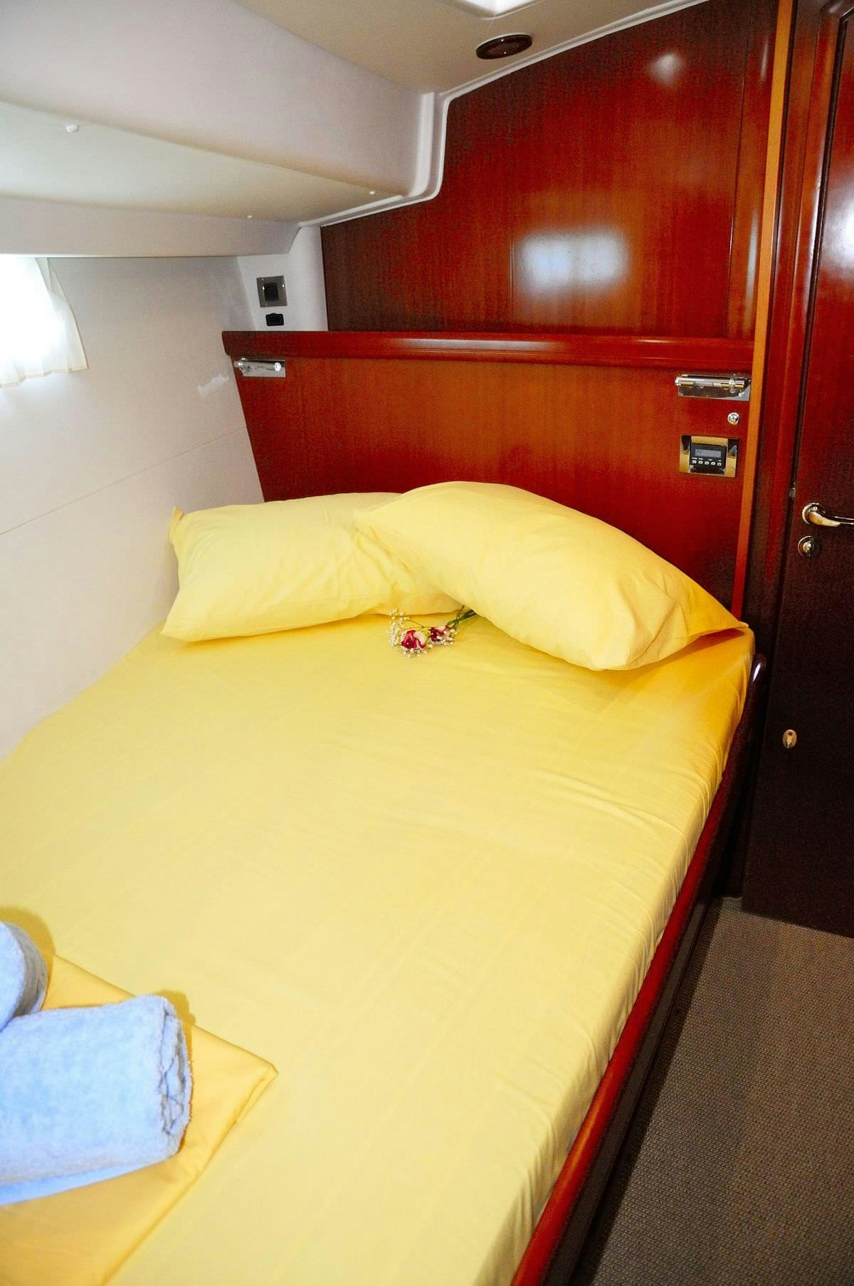 a bed with yellow sheets aboard SEA STAR Yacht for Charter