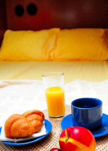 a plate of food and a glass of juice on a table aboard SEA STAR Yacht for Charter