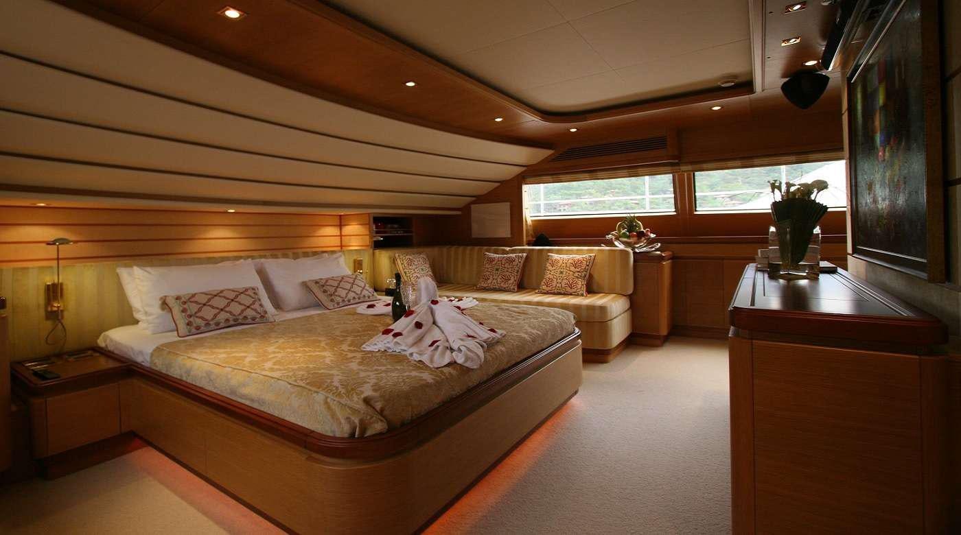 a bedroom with a bed and a desk aboard SEA LION II Yacht for Charter