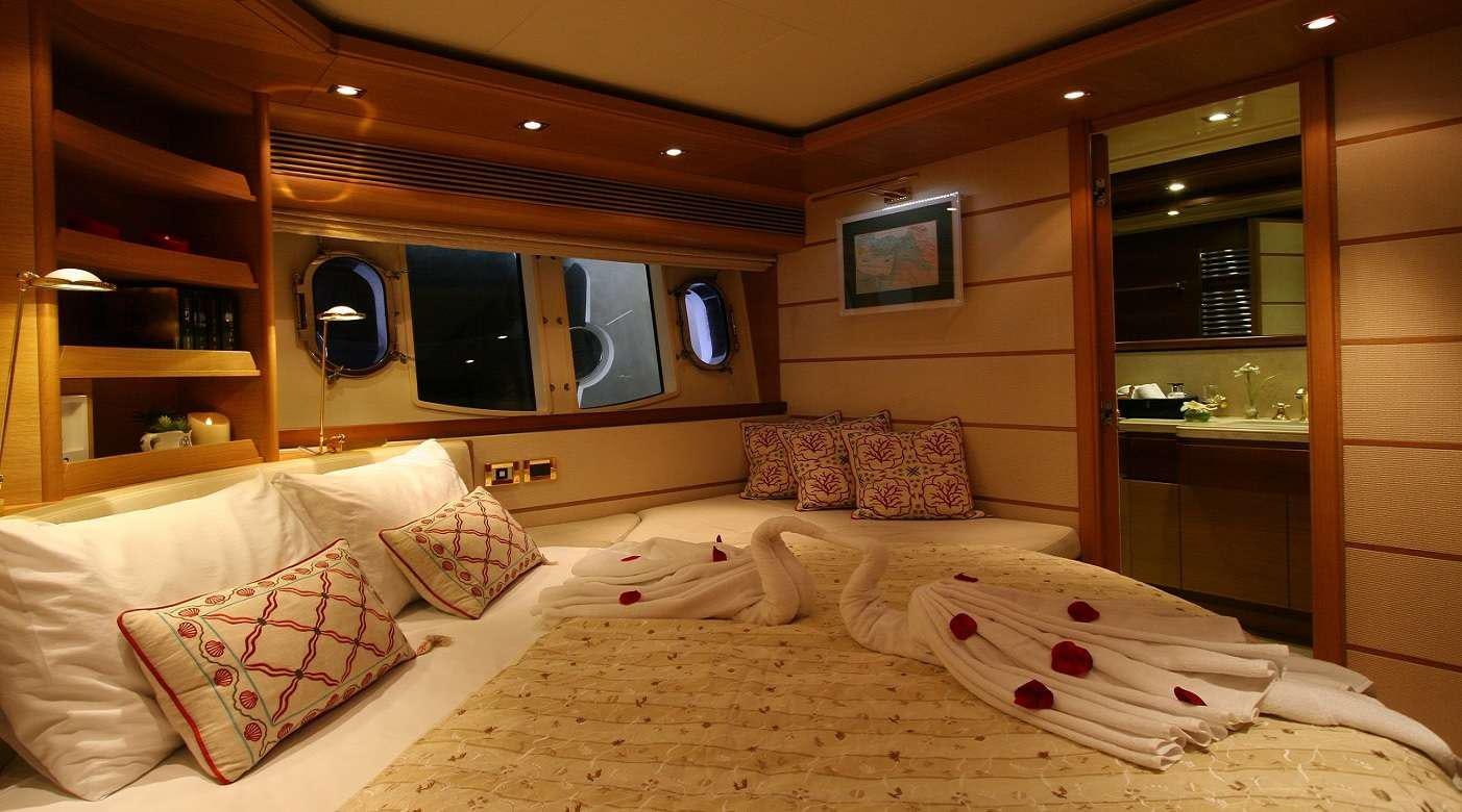 a room with a bed and a mirror aboard SEA LION II Yacht for Charter
