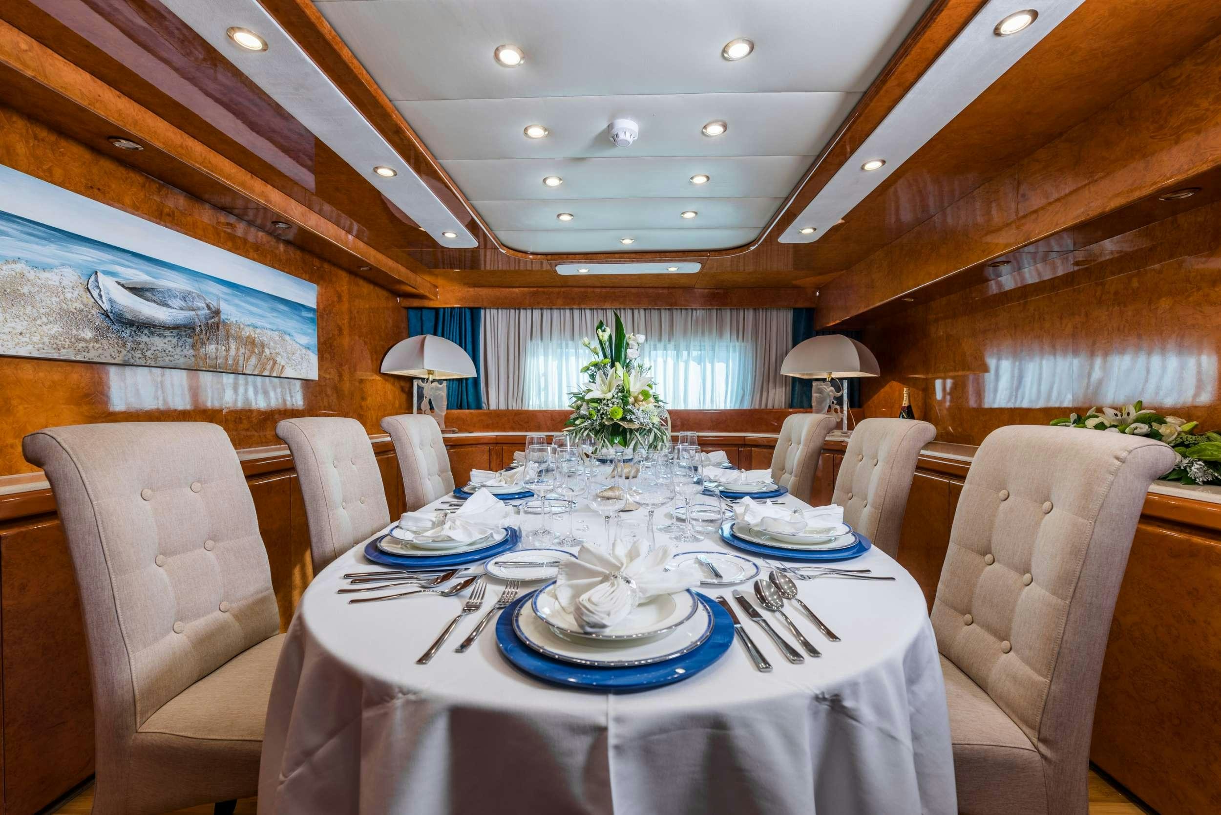 a dining room with a table set aboard BORA BORA Yacht for Charter