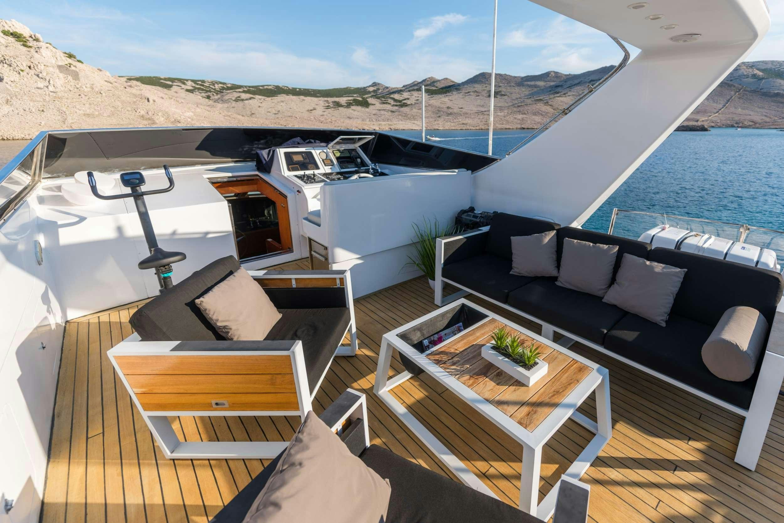 a deck with a table and chairs on it aboard BORA BORA Yacht for Charter