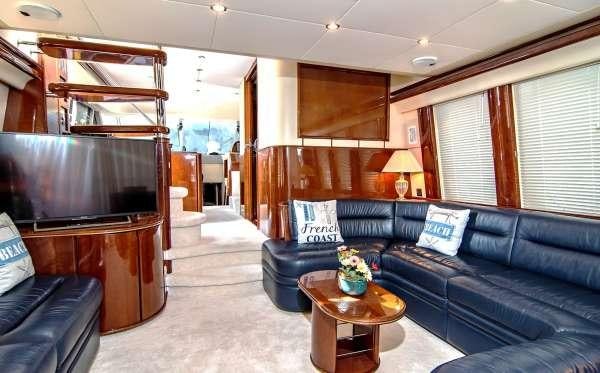 a living room with a blue couch aboard VENALI Yacht for Charter