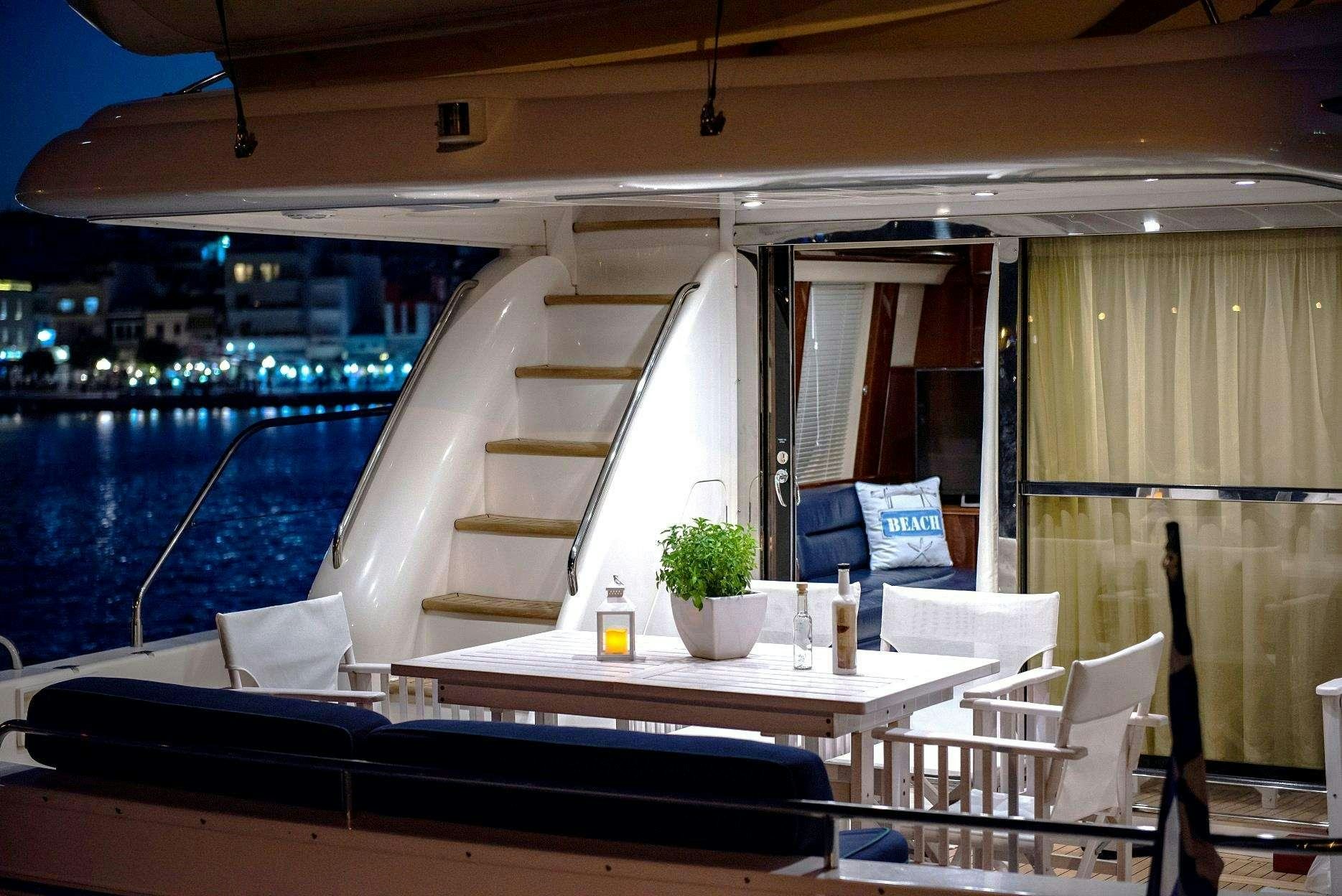 a balcony with a table and chairs aboard VENALI Yacht for Charter