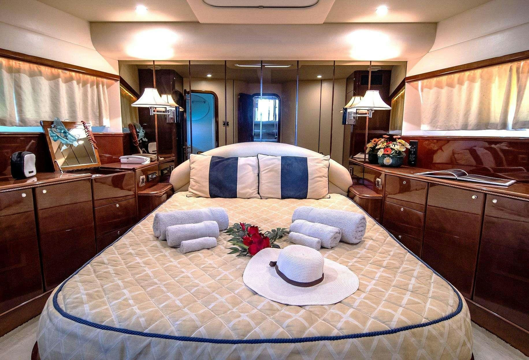 a large bedroom with a bed and a desk aboard VENALI Yacht for Charter
