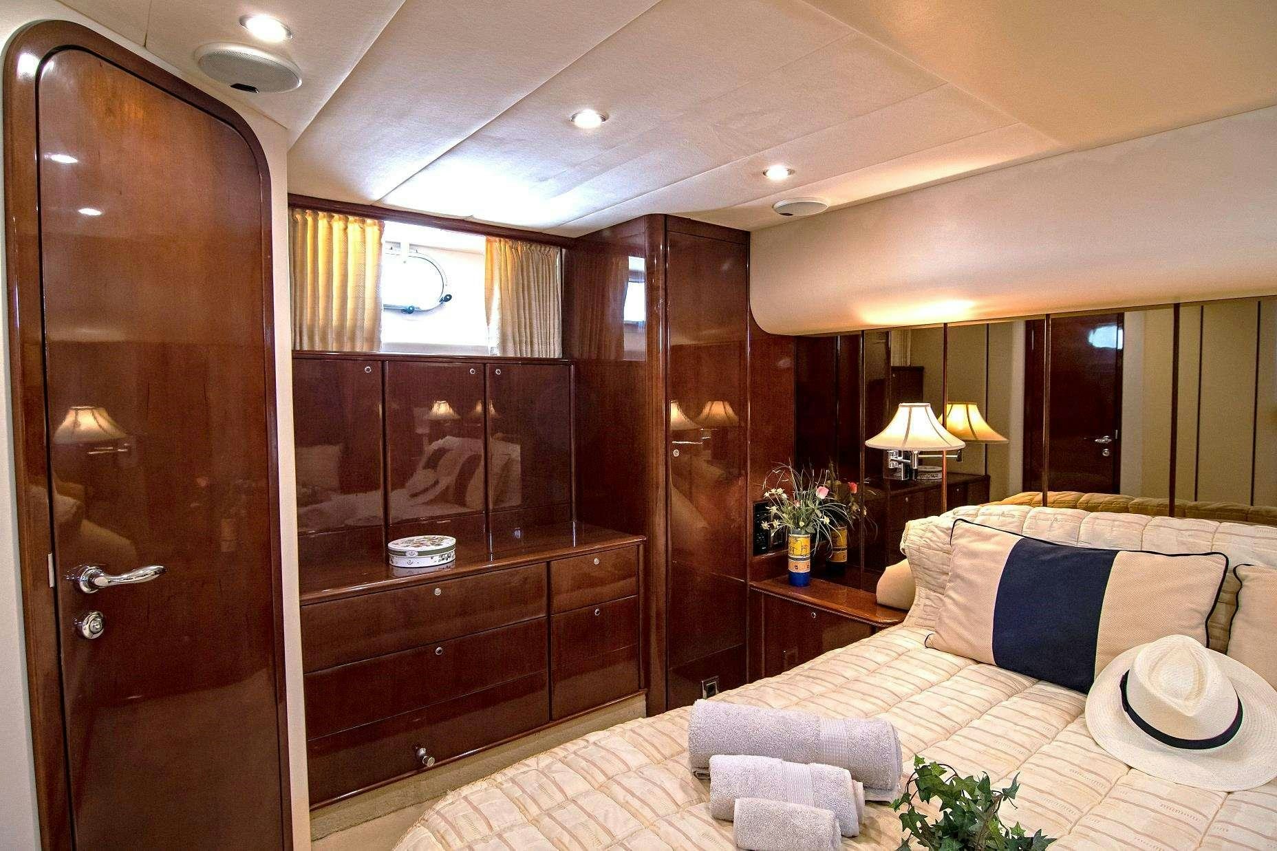 a room with a bed and a door aboard VENALI Yacht for Charter