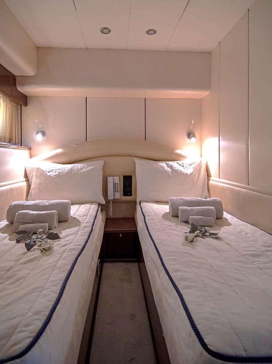 a room with a bed and a couch aboard VENALI Yacht for Charter