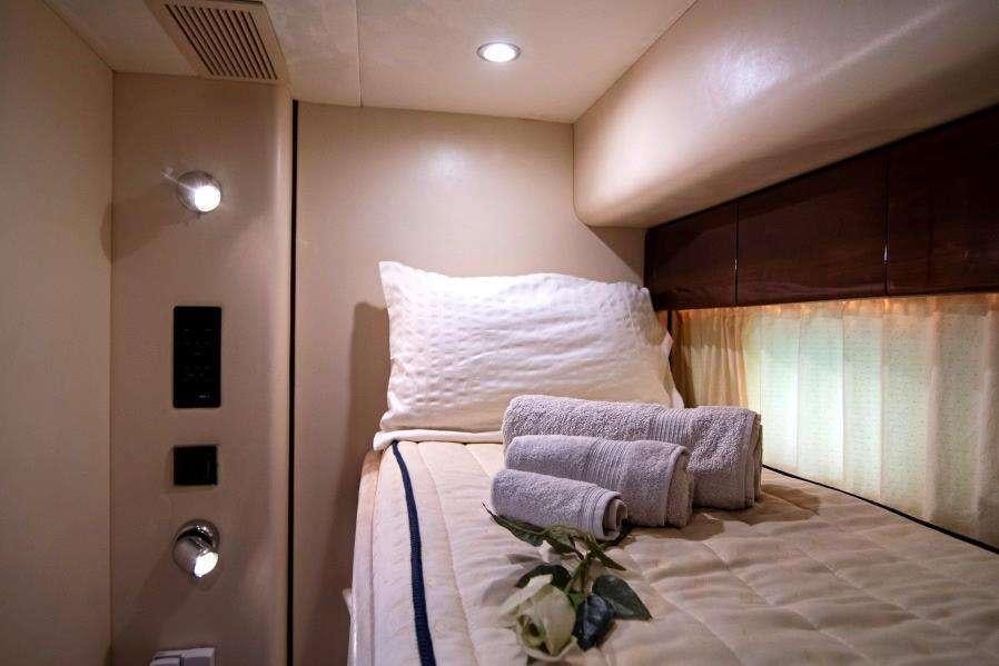 a bed with a white sheet aboard VENALI Yacht for Charter