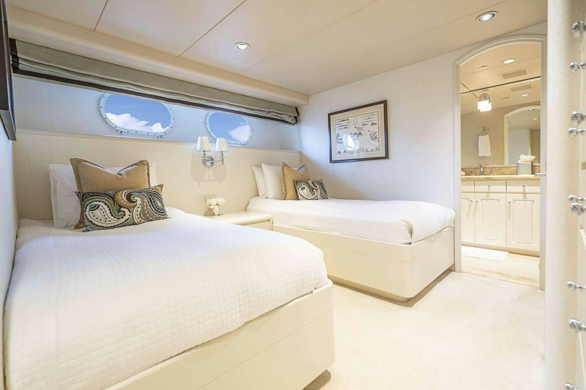 a room with a couple of beds aboard CHERISH Yacht for Charter