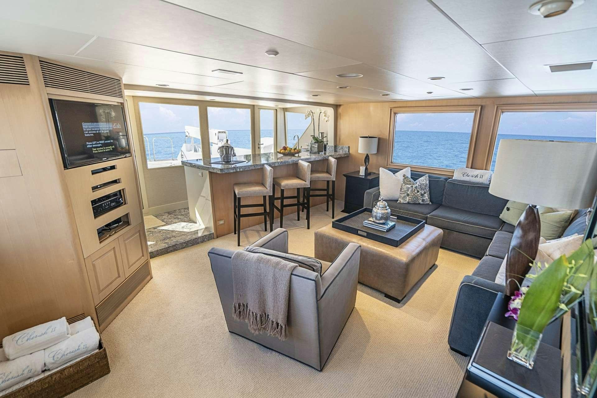 a living room with a couch and a tv aboard CHERISH Yacht for Charter