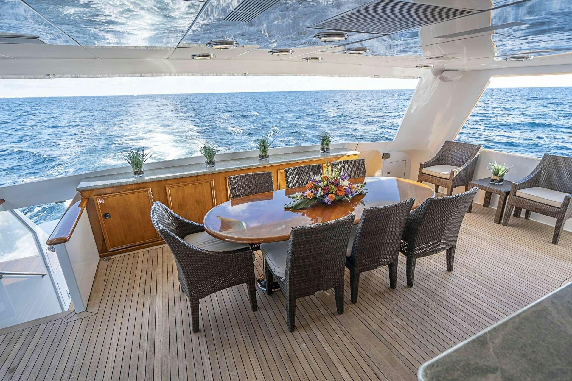 a table and chairs on a deck aboard CHERISH Yacht for Charter