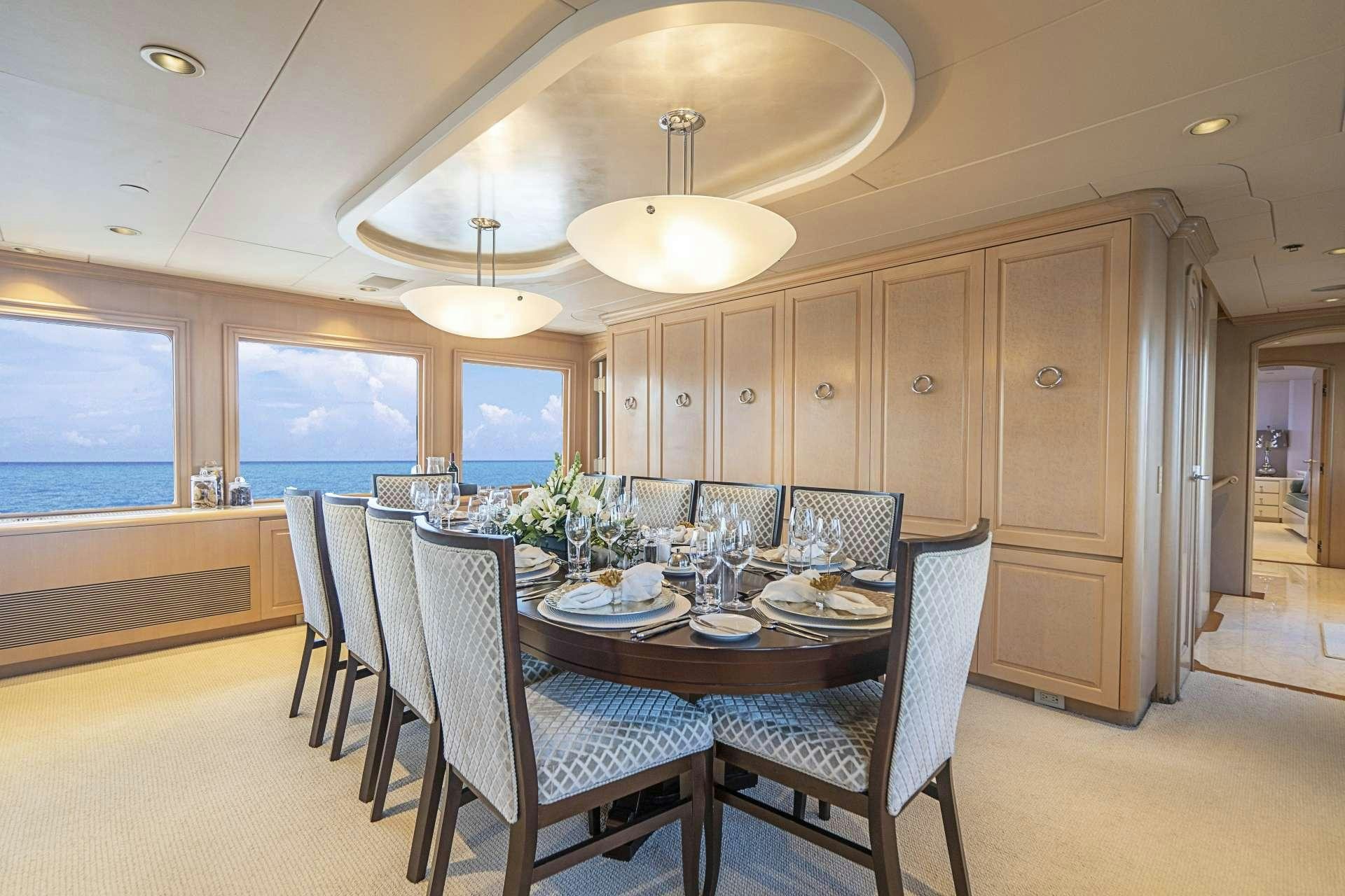 a dining room with a table and chairs aboard CHERISH Yacht for Charter