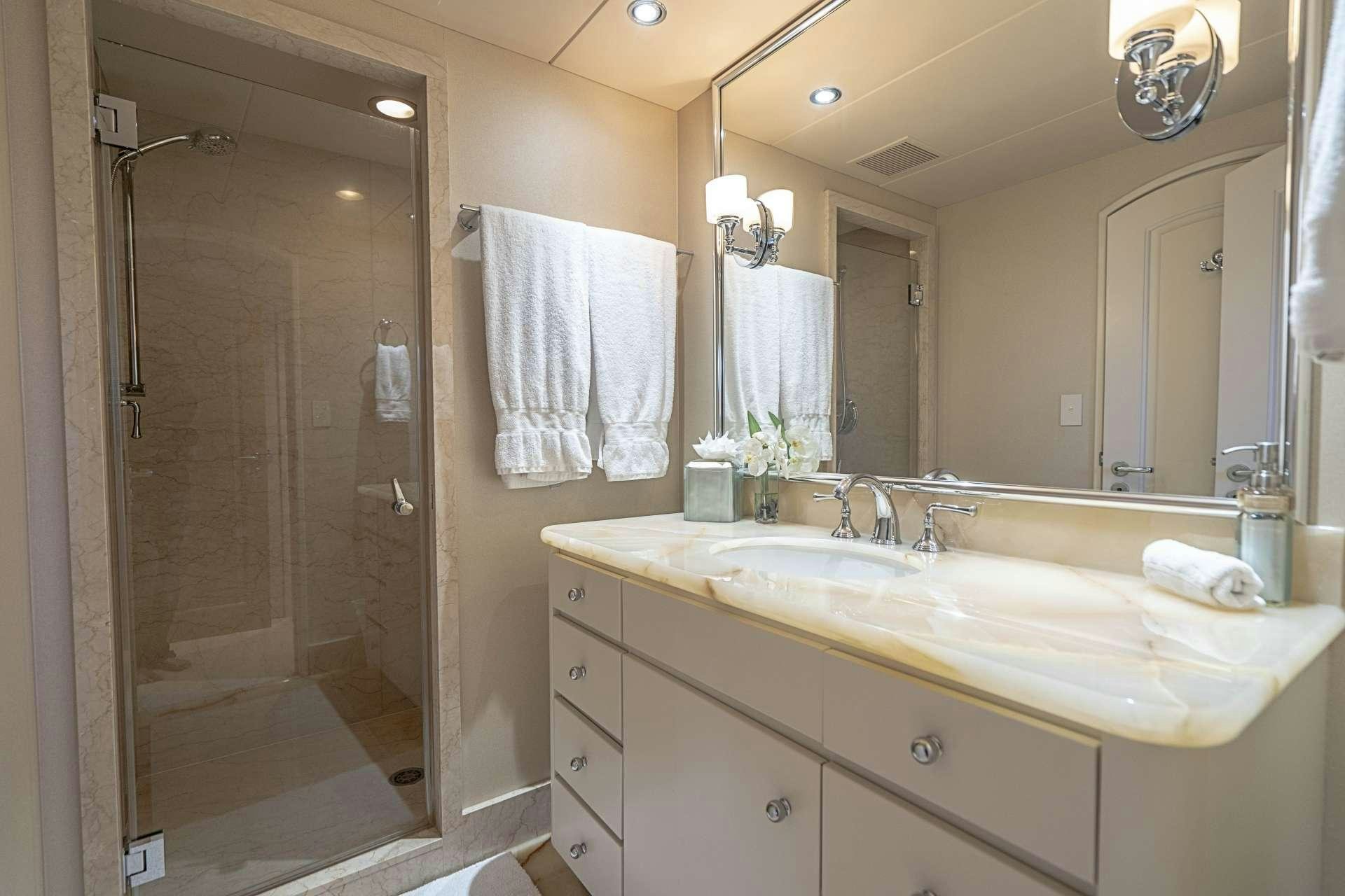 a bathroom with a shower and sink aboard CHERISH Yacht for Charter