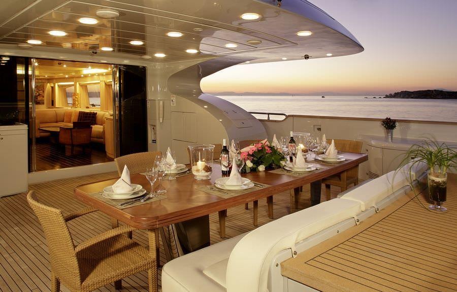 a long table with glasses on it aboard GLAROS Yacht for Charter