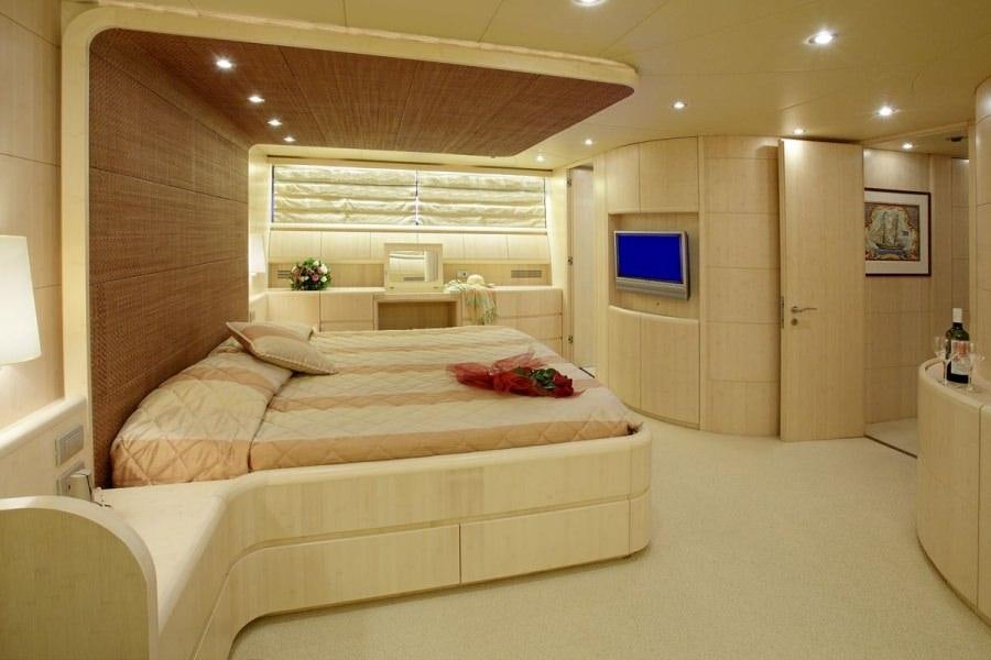 a large bedroom with a large bed aboard GLAROS Yacht for Charter