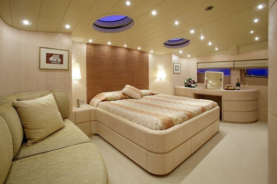 a room with a bed and a couch aboard GLAROS Yacht for Charter