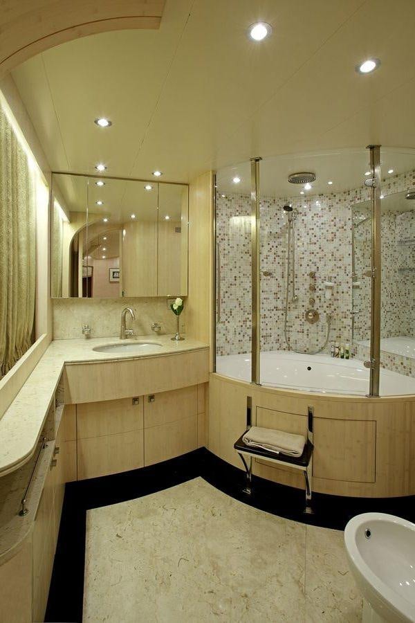 a bathroom with a tub sink and a sink aboard GLAROS Yacht for Charter