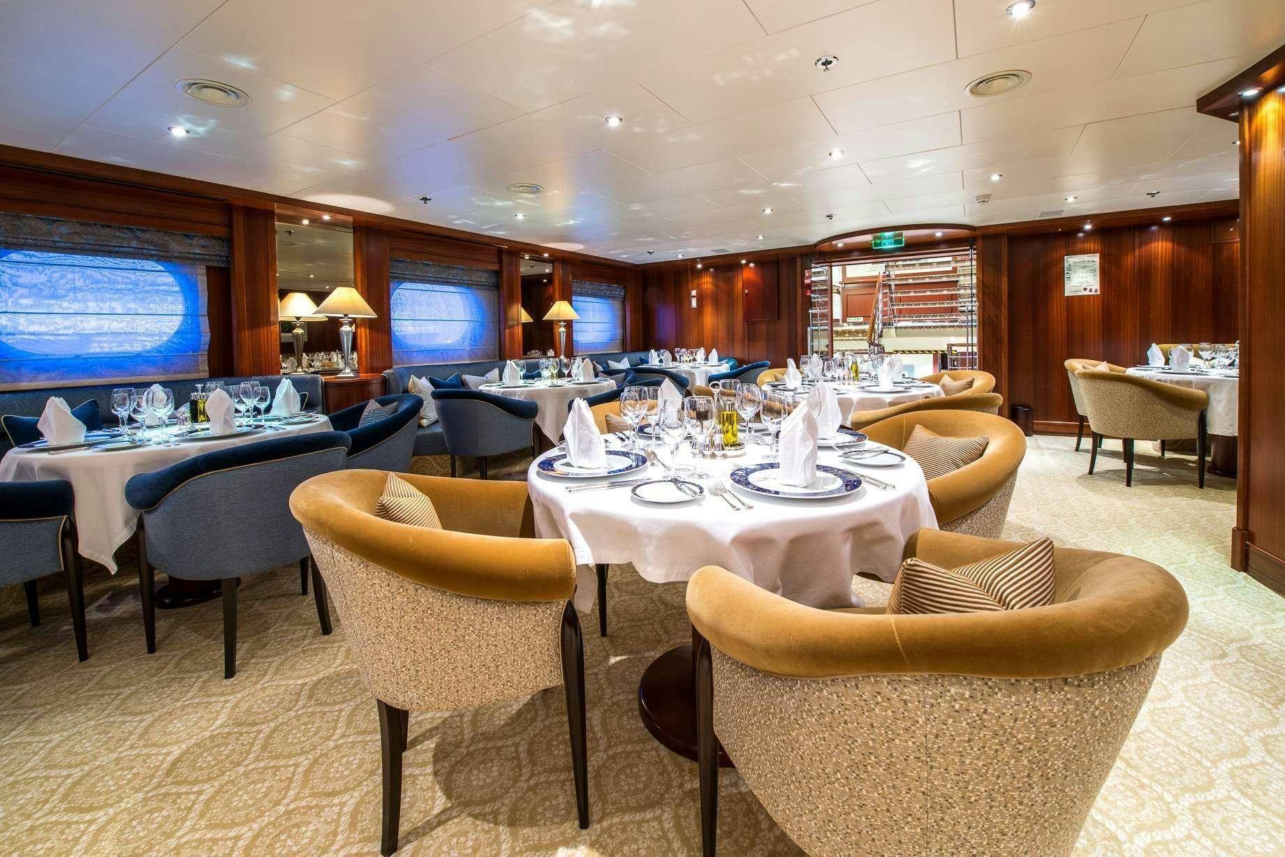 a room with tables and chairs aboard LAUREN L Yacht for Charter