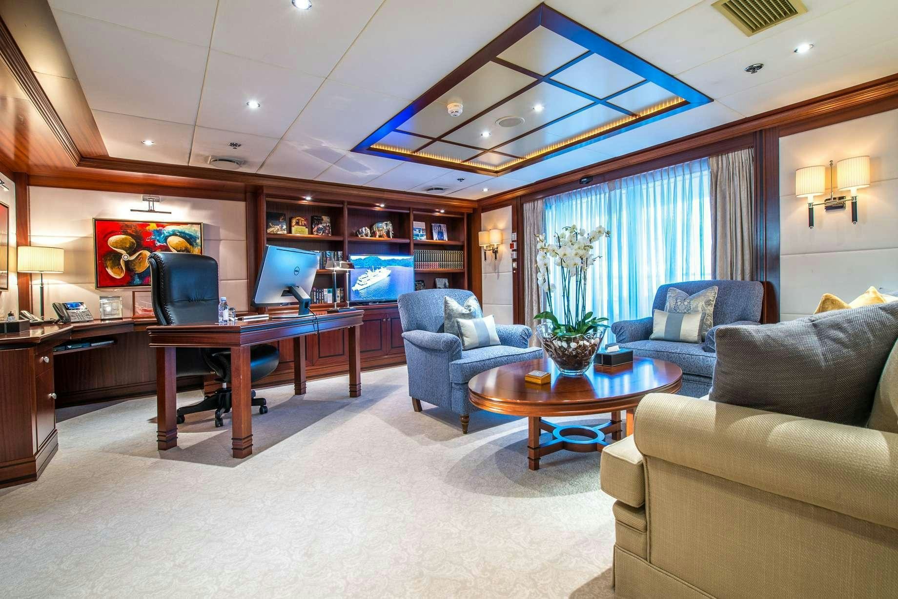 a living room with a large table and chairs aboard LAUREN L Yacht for Charter