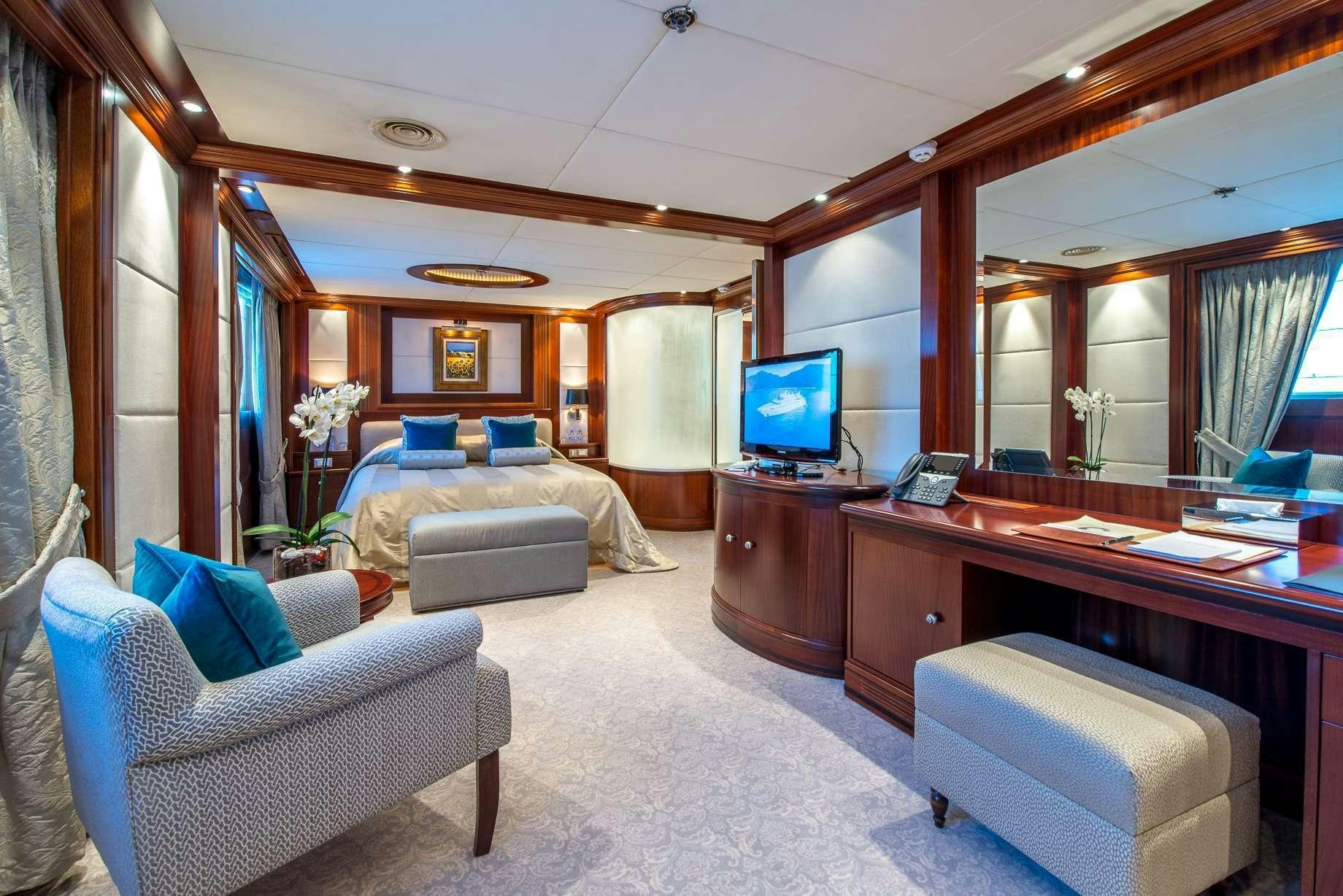 a room with a bed and a desk aboard LAUREN L Yacht for Charter