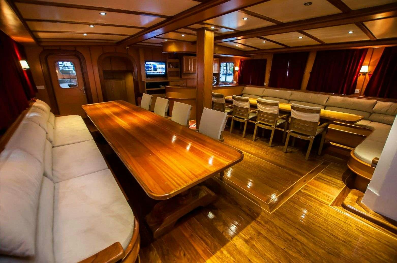 a large room with a table and chairs aboard TERSANE 8 Yacht for Charter