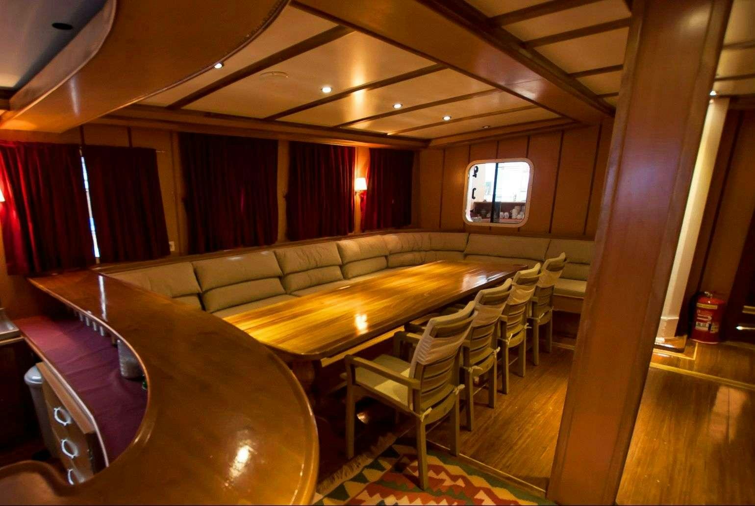 a room with a couch and a television aboard TERSANE 8 Yacht for Charter